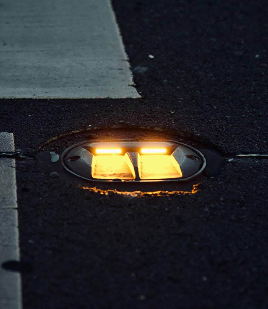 In-road LED light installed in crosswalk